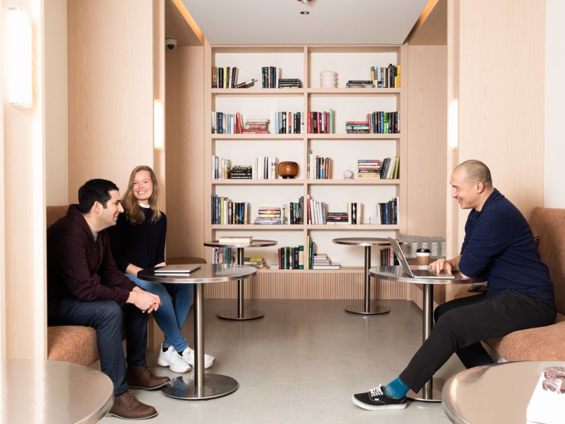 Adyen team members gathered in library-like area of office